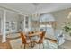 Stylish dining room with wainscoting, a crystal chandelier, and a bright window overlooking the yard at 296 Shoreline Dr, Princeton, NC 27569