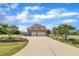 Long driveway leads to a three-car garage, framed by landscaping and mature trees at 296 Shoreline Dr, Princeton, NC 27569