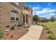 Beautifully landscaped front yard leading to a charming brick home with an inviting entrance at 296 Shoreline Dr, Princeton, NC 27569