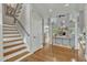 Spacious foyer with hardwood floors, staircase, and views into the living area with large windows at 296 Shoreline Dr, Princeton, NC 27569