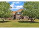 Charming two-story brick home with a well-manicured lawn, mature trees, and an inviting front porch at 296 Shoreline Dr, Princeton, NC 27569