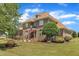 Beautiful two-story brick home featuring mature landscaping and a cozy bench in the front yard at 296 Shoreline Dr, Princeton, NC 27569