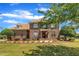 Traditional brick home with manicured landscaping, an American flag, and an arched window above the front door at 296 Shoreline Dr, Princeton, NC 27569