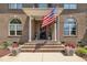 Inviting front porch with an American flag and decorative planters flanking the entry at 296 Shoreline Dr, Princeton, NC 27569