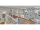 Open hallway overlooking the foyer with hardwood flooring and decorative railing at 296 Shoreline Dr, Princeton, NC 27569