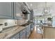 The kitchen features stone countertops, custom cabinets, stainless steel appliances, and eat-in breakfast area at 296 Shoreline Dr, Princeton, NC 27569