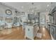 Open-concept kitchen and living area with an island, granite countertops, and custom cabinetry at 296 Shoreline Dr, Princeton, NC 27569