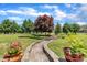Landscaped yard with stone walkway, flowering bushes, and trees at 296 Shoreline Dr, Princeton, NC 27569