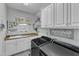 Bright laundry room with modern washer and dryer units, ample cabinet space, and a sink at 296 Shoreline Dr, Princeton, NC 27569