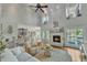 Open living room features a fireplace, hardwood floors, and an open kitchen concept for modern living at 296 Shoreline Dr, Princeton, NC 27569