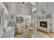 Elegant living room featuring a fireplace, hardwood floors, and an open layout to the kitchen and dining area at 296 Shoreline Dr, Princeton, NC 27569
