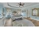 Comfortable main bedroom with ornate bed frame, ceiling fan and wood-look flooring at 296 Shoreline Dr, Princeton, NC 27569