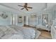 Spacious main bedroom with a sitting area, decorative chest, and light blue walls at 296 Shoreline Dr, Princeton, NC 27569