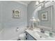 Charming powder room featuring vintage-inspired vanity and decorative wallpaper at 296 Shoreline Dr, Princeton, NC 27569