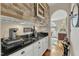 Stylish wet bar area with granite countertops, white cabinets, and unique decor at 296 Shoreline Dr, Princeton, NC 27569
