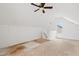 Loft space with unfinished flooring, sloped ceilings, and natural light at 3223 Polite Ln, Raleigh, NC 27610