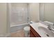 Bright bathroom with white shower and vanity with cherry cabinets at 3223 Polite Ln, Raleigh, NC 27610