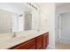 Bathroom features dual sinks, a large mirror, cherry cabinets and modern lighting at 3223 Polite Ln, Raleigh, NC 27610