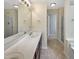 Bright bathroom features double sink vanity, neutral tile floors, and separate shower at 3223 Polite Ln, Raleigh, NC 27610