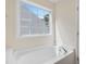 Bathroom features a white garden tub with a window that provides natural light at 3223 Polite Ln, Raleigh, NC 27610