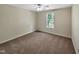 Empty bedroom features neutral carpet and a large window at 3223 Polite Ln, Raleigh, NC 27610