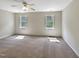 Spacious bedroom with carpet flooring, ceiling fan, and large windows at 3223 Polite Ln, Raleigh, NC 27610