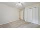 Spacious bedroom with neutral walls, plush carpet, double closet doors and a ceiling fan at 3223 Polite Ln, Raleigh, NC 27610