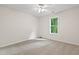 Cozy bedroom with neutral walls, plush carpet, and a ceiling fan at 3223 Polite Ln, Raleigh, NC 27610