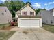 Charming two-story home with a two car garage, red shutters, and well-maintained landscaping at 3223 Polite Ln, Raleigh, NC 27610