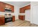 Charming kitchen featuring stainless steel appliances, ample counter space and warm wood cabinets at 3223 Polite Ln, Raleigh, NC 27610