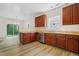 This is a great kitchen with stainless steel appliances, and warm wood cabinets and light wood flooring at 3223 Polite Ln, Raleigh, NC 27610