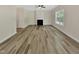 Spacious living room with hardwood flooring, a fireplace, neutral paint, and lots of natural light at 3223 Polite Ln, Raleigh, NC 27610
