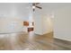 Bright, open-concept living space with hardwood floors, ceiling fan, and chandelier at 3223 Polite Ln, Raleigh, NC 27610