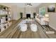 Bright, staged living room with a fireplace, modern furniture, and large windows at 3223 Polite Ln, Raleigh, NC 27610