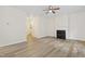 Open living area with fireplace, ceiling fan, and hardwood floors at 3223 Polite Ln, Raleigh, NC 27610