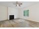 Open living area with fireplace, ceiling fan, and large window offering natural light at 3223 Polite Ln, Raleigh, NC 27610