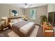 Staged primary bedroom with large bed, stylish decor, and a big window at 3223 Polite Ln, Raleigh, NC 27610
