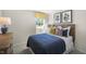 Bright bedroom featuring a woven headboard, a window with yellow valance, and blue and white bedding at 3608 Sorda Ct, Raleigh, NC 27610