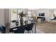 Stylish dining room with a modern table and chairs, seamlessly connected to a living room and bedroom at 3608 Sorda Ct, Raleigh, NC 27610