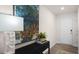 Inviting entryway with a decorative table, lamp, large modern art, and direct access to the main living areas at 3608 Sorda Ct, Raleigh, NC 27610