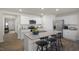 Modern kitchen featuring granite countertops, a kitchen island with bar stools, and stainless steel appliances at 3608 Sorda Ct, Raleigh, NC 27610
