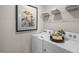Functional laundry area with appliances, wire shelving, decorative accents, and framed artwork at 3608 Sorda Ct, Raleigh, NC 27610