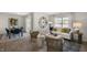 Open-concept living room and dining area with hardwood floors, lots of light, and modern decor at 3608 Sorda Ct, Raleigh, NC 27610