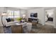 Cozy living room with a white sofa, accent chairs, and a view into the bedroom at 3608 Sorda Ct, Raleigh, NC 27610