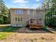 A large backyard with a wooden deck and two story house at 3705 Cassaro Ln, Zebulon, NC 27597