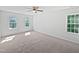 Bedroom featuring carpet, three windows, and a ceiling fan at 3705 Cassaro Ln, Zebulon, NC 27597