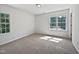 Bright bedroom with carpet and two windows providing natural light at 3705 Cassaro Ln, Zebulon, NC 27597