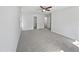 Spacious carpeted bedroom featuring a ceiling fan and multiple doorways at 3705 Cassaro Ln, Zebulon, NC 27597