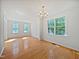 Open dining room with hardwood floors, bright windows, and chandelier at 3705 Cassaro Ln, Zebulon, NC 27597