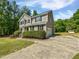 Charming two-story home featuring gray siding, black shutters, and a well-manicured lawn at 3705 Cassaro Ln, Zebulon, NC 27597
